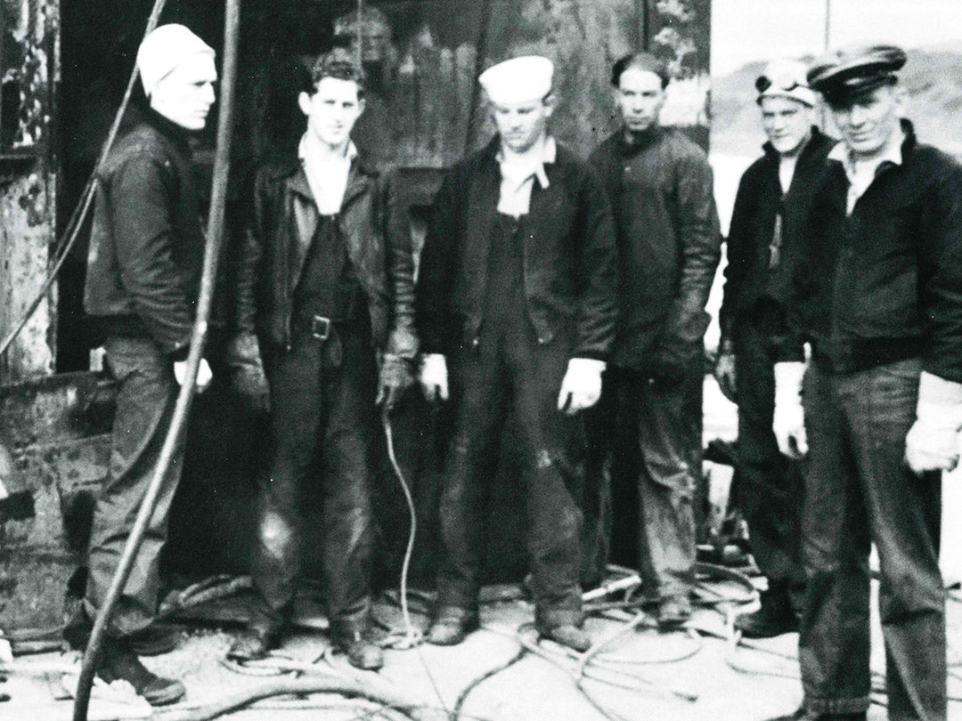 A salvage crew wearing blue cold weather and dungarees in 1943.